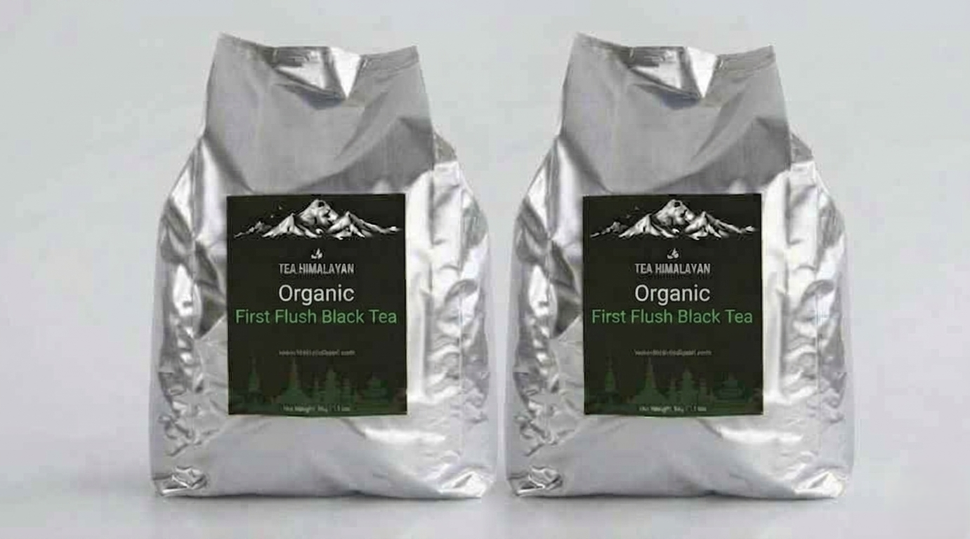 Two silver foil bags of Tea Himalayan Organic First Flush Black Tea standing side by side against a light gray background.