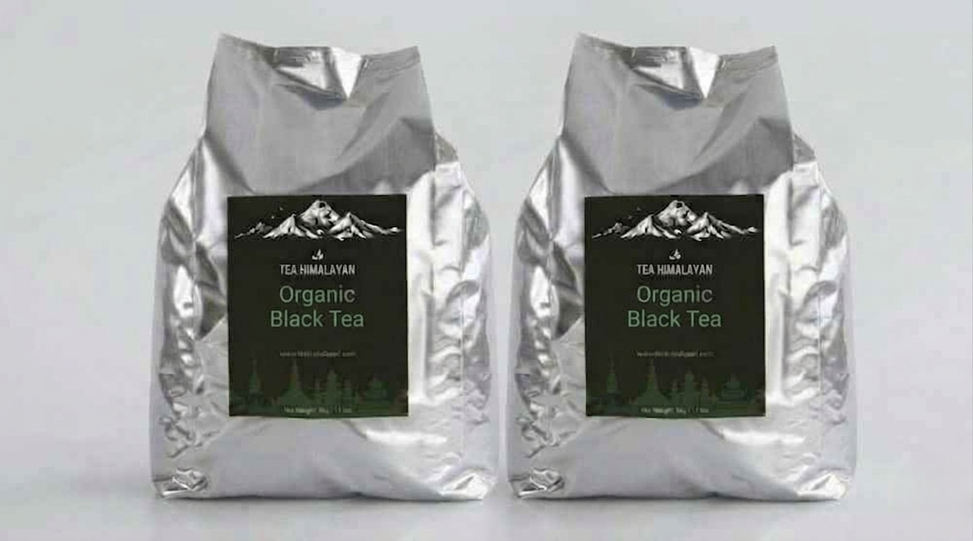 Two silver foil bags of Tea Himalayan Organic Black Tea standing side by side on a light gray background.
