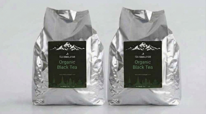 Two silver foil bags of Tea Himalayan Organic Black Tea standing side by side on a light gray background.