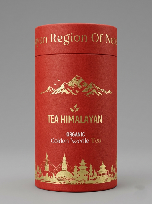 A cylindrical red cardboard tea tin with gold foil text reading 'TEA HIMALAYAN' and 'ORGANIC Golden Needle Tea,' plus gold mountain and building silhouettes, photographed on a neutral gray background.