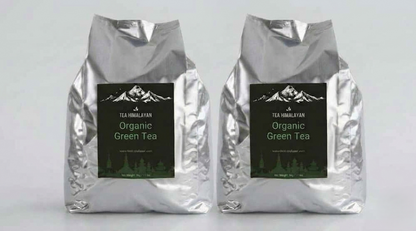 Two silver foil bags of Tea Himalayan Organic Green Tea standing side by side against a light gray background.