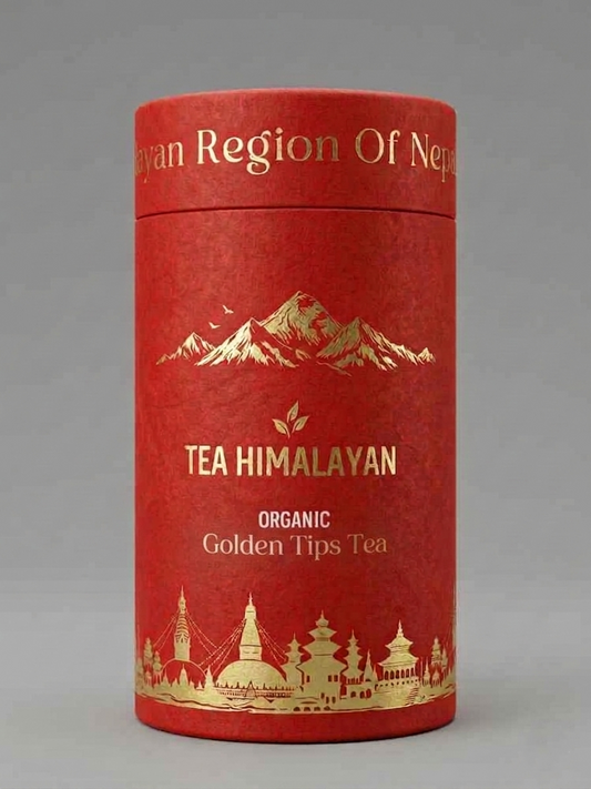 A red cylindrical cardboard tea tin with gold foil text reading 'TEA HIMALAYAN' and 'ORGANIC Golden Tips Tea,' plus gold mountain and architectural illustrations, photographed on a neutral gray background.